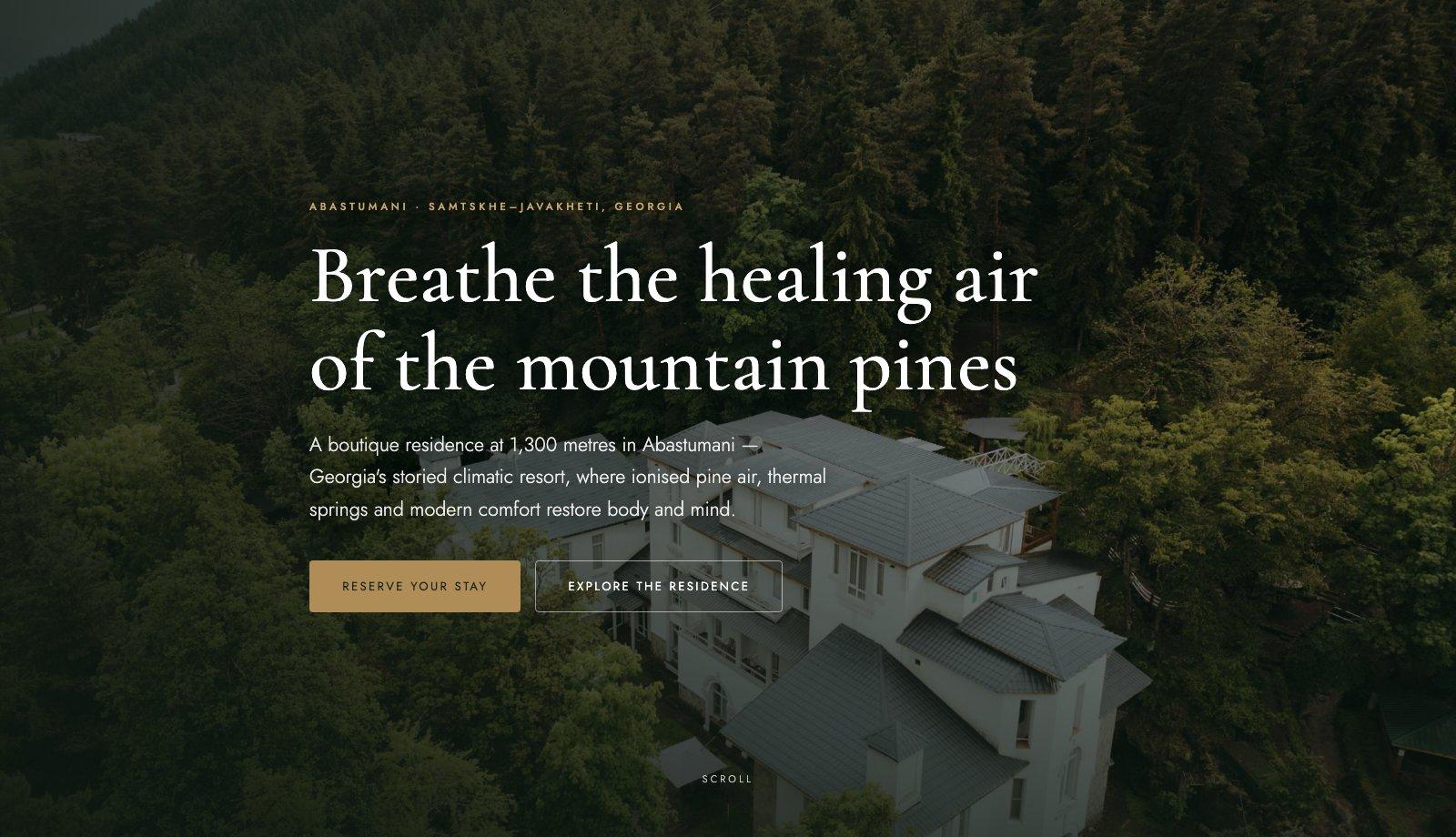 The Abastumani Residence homepage: an aerial photograph of the white residence set in dense pine forest, overlaid with the headline 'Breathe the healing air of the mountain pines'